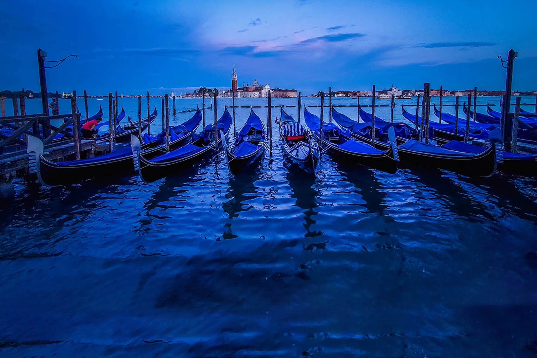 Gondolas moored by Saint Mark square with San Giorgio di Maggiore church in the background - Venice, Venezia, Italy, Europe